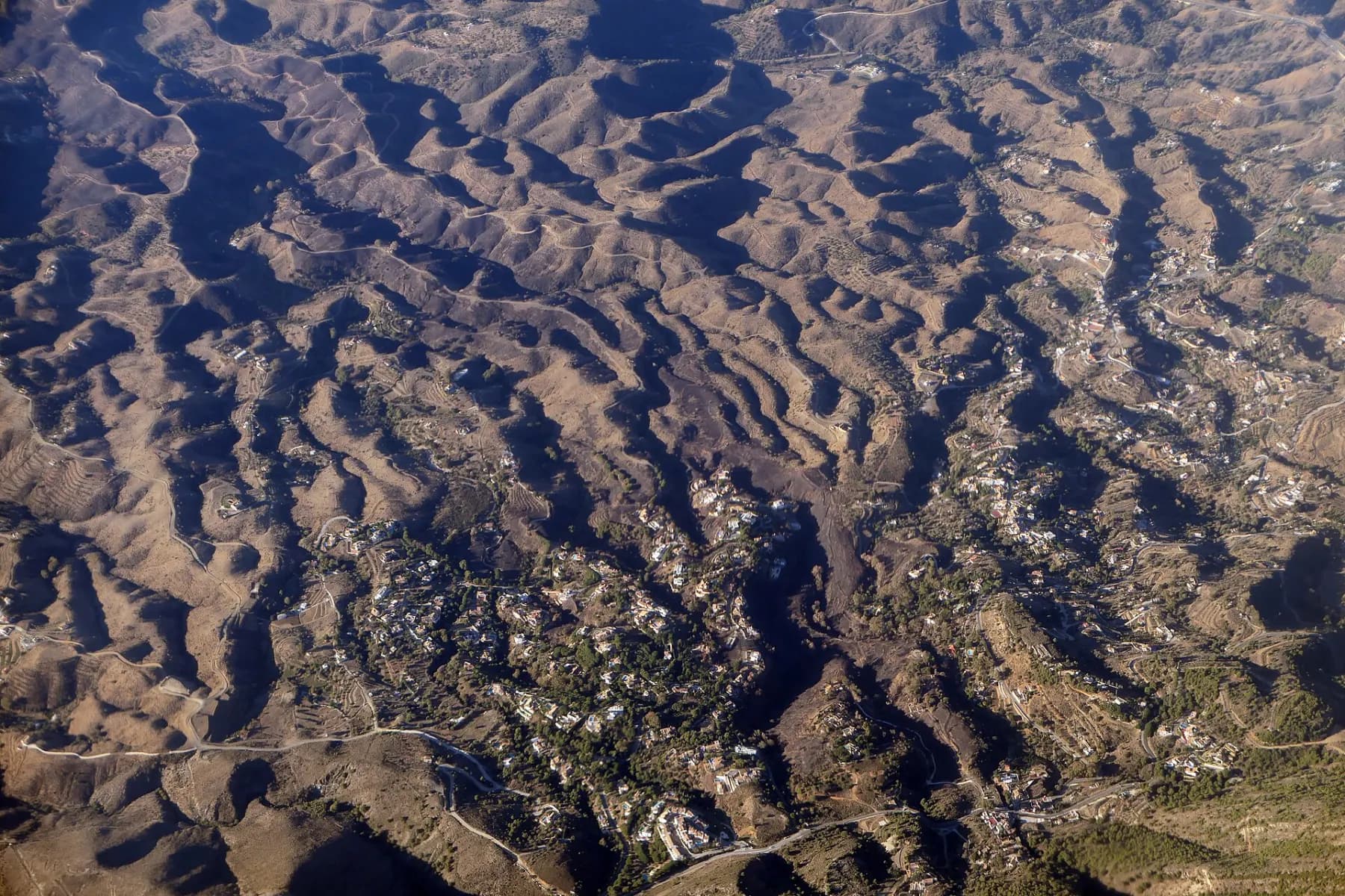 Aerial view of the hills and scattered houses of Valtocado, Mijas