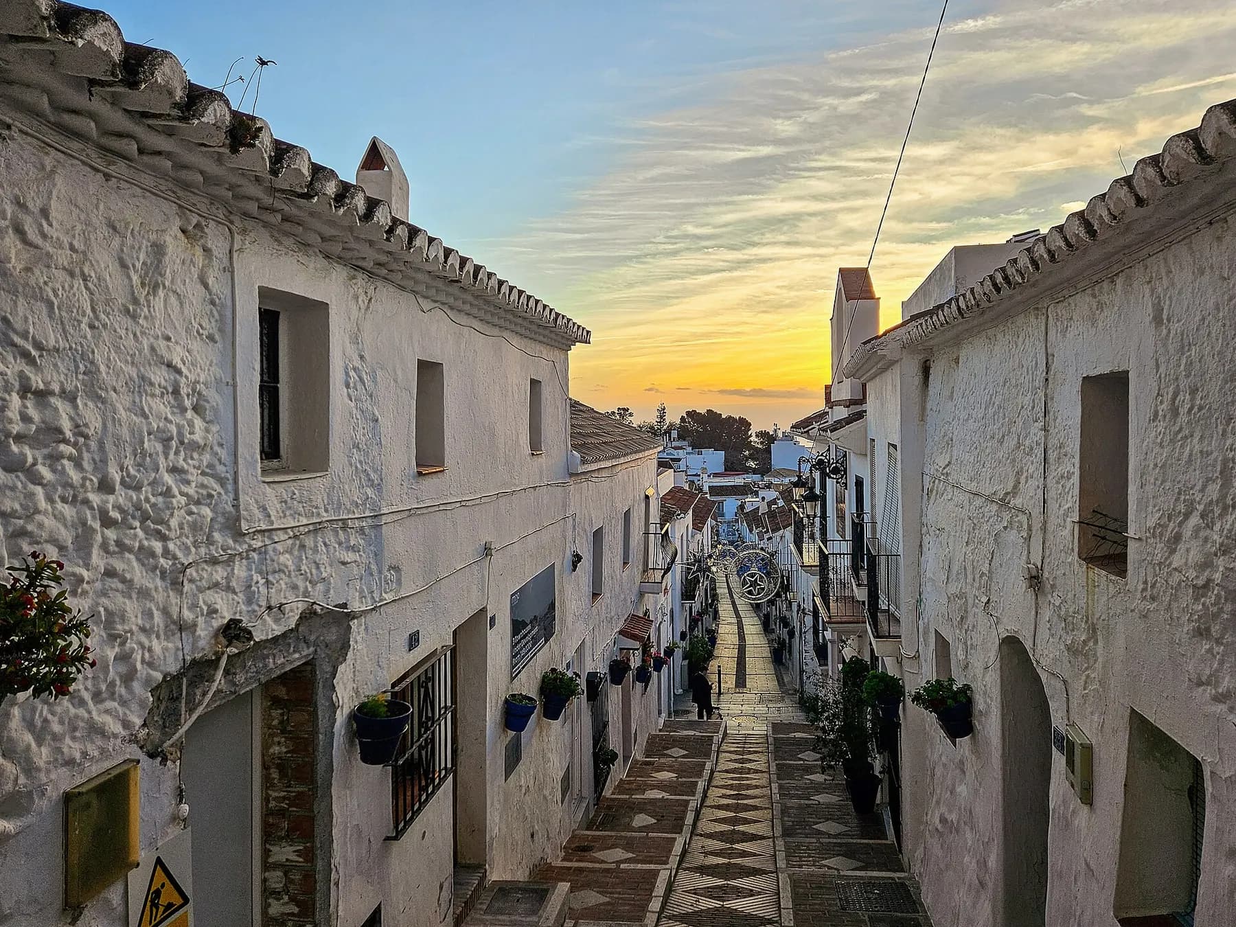 Calle San Sebastián, a whitewashed street in Mijas Pueblo, at sunrise